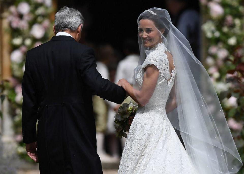 Pippa Middleton is escorted into the church by her father: AFP/Getty