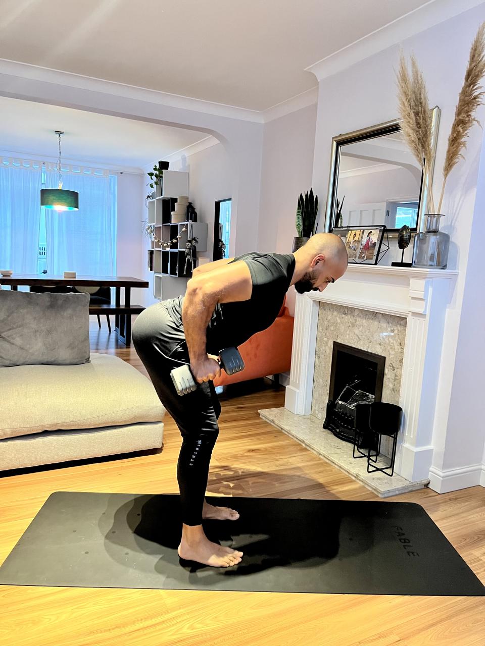 Personal trainer Ali Malik demonstrating the  dumbbell bent-over row