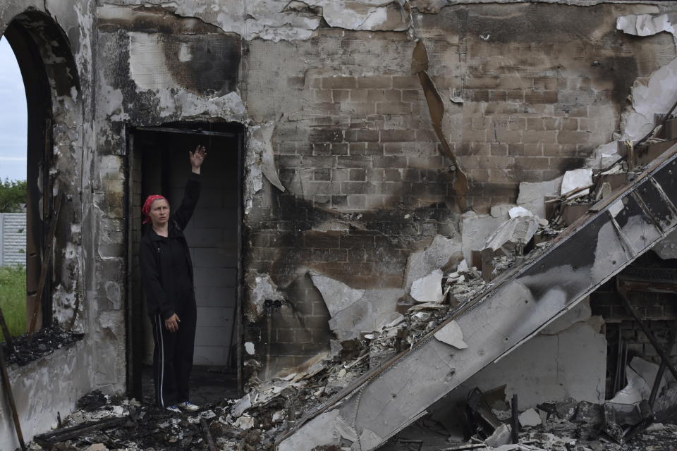 Valentina, 53, a local woman, stands inside of Evangelical Christian Baptists prayer house which was destroyed yesterday by a Russian attack in Orihiv, Ukraine, on Monday, May 22, 2023. (AP Photo/Andriy Andriyenko)