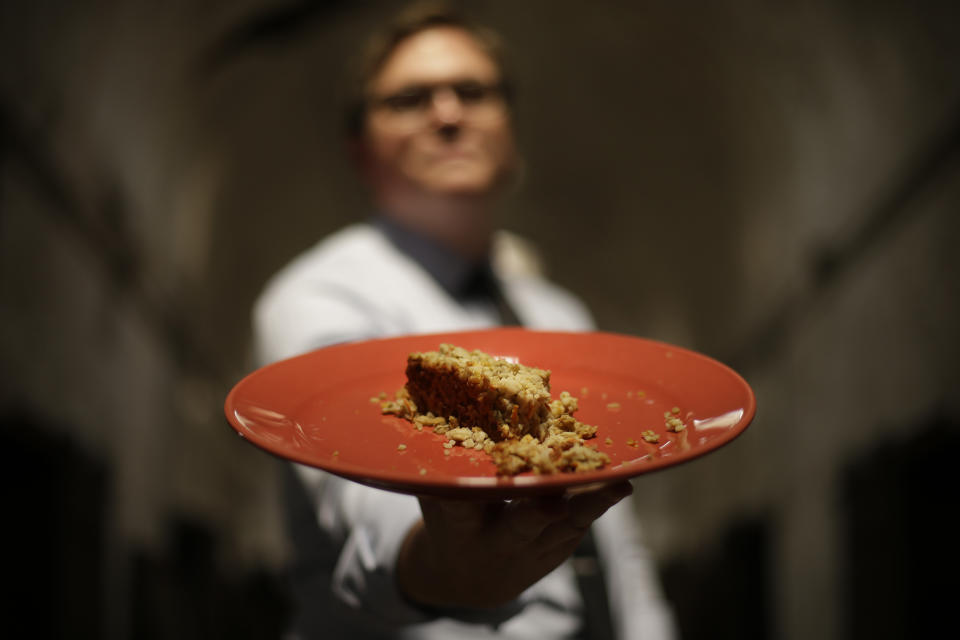 In this Friday, May 31, 2013 photo, director of public programming, Sean kelly displays a plate of Nutraloaf, presently served in Pennsylvania prisons as a “behavior modified meal,” at Eastern State Penitentiary in Philadelphia. The historic penitentiary plans to serve visitors sample meals from the 1800s, 1900s and today on June 8th and 9th. (AP Photo/Matt Rourke)