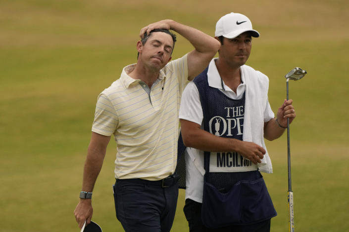 Rory McIlroy of Northern Ireland walk from the 18th green with his caddie after finishing his final round of the British Open golf championship on the Old Course at St. Andrews, Scotland, Sunday July 17, 2022. (AP Photo/Gerald Herbert)
