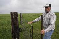 Brian Sprenger closes a gate Wednesday, June 21, 2023, in Sidney, Neb. North America's grassland birds are in trouble 50 years after adoption of the Endangered Species Act as habitat loss, land degradation and climate change threaten what remains of a once-vast ecosystem. Sprenger is a rancher who implements rotational grazing to improve and preserve grassland habitat. (AP Photo/Brittany Peterson)