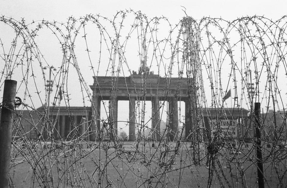 6/11/1961-West Berlin, West Germany- Wired shut, the Brandenburg Gate on the dividing line between East and West Berlin looms beyond this barbed wire entanglement which, surprisingly, is on the Western side. It was built up on orders of Berlin's British military command, which described the barrier as just a "normal safety precaution." East Berlin authorities have closed off the other side of the gate for weeks. Picture- Corbis Images