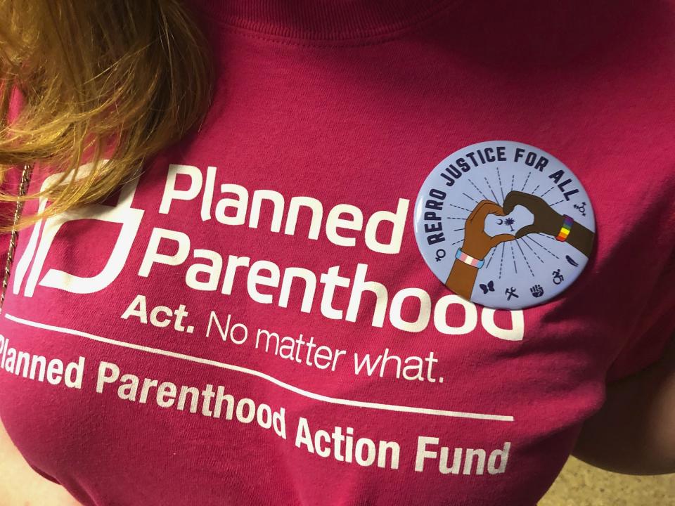 Opponents of a bill banning abortions in South Carolina after a fetal heartbeat is detected wore similar buttons at a state Senate subcommittee public hearing on Tuesday, Sept. 10, 2019, in Columbia, South Carolina. The bill has already passed the House and is supported by the governor. (AP Photo / Jeffrey Collins)