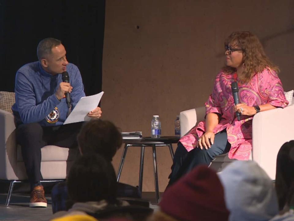 Kevin Chief, co-founder of Winnipeg Aboriginal Sport Achievement Centre, asks Kim Davis, executive vice-president of social impact, growth initiatives and legislative affairs for the National Hockey League, a question during an event for youth at the Canadian Museum for Human Rights on Wednesday in Winnipeg. (Trevor Brine/CBC - image credit)