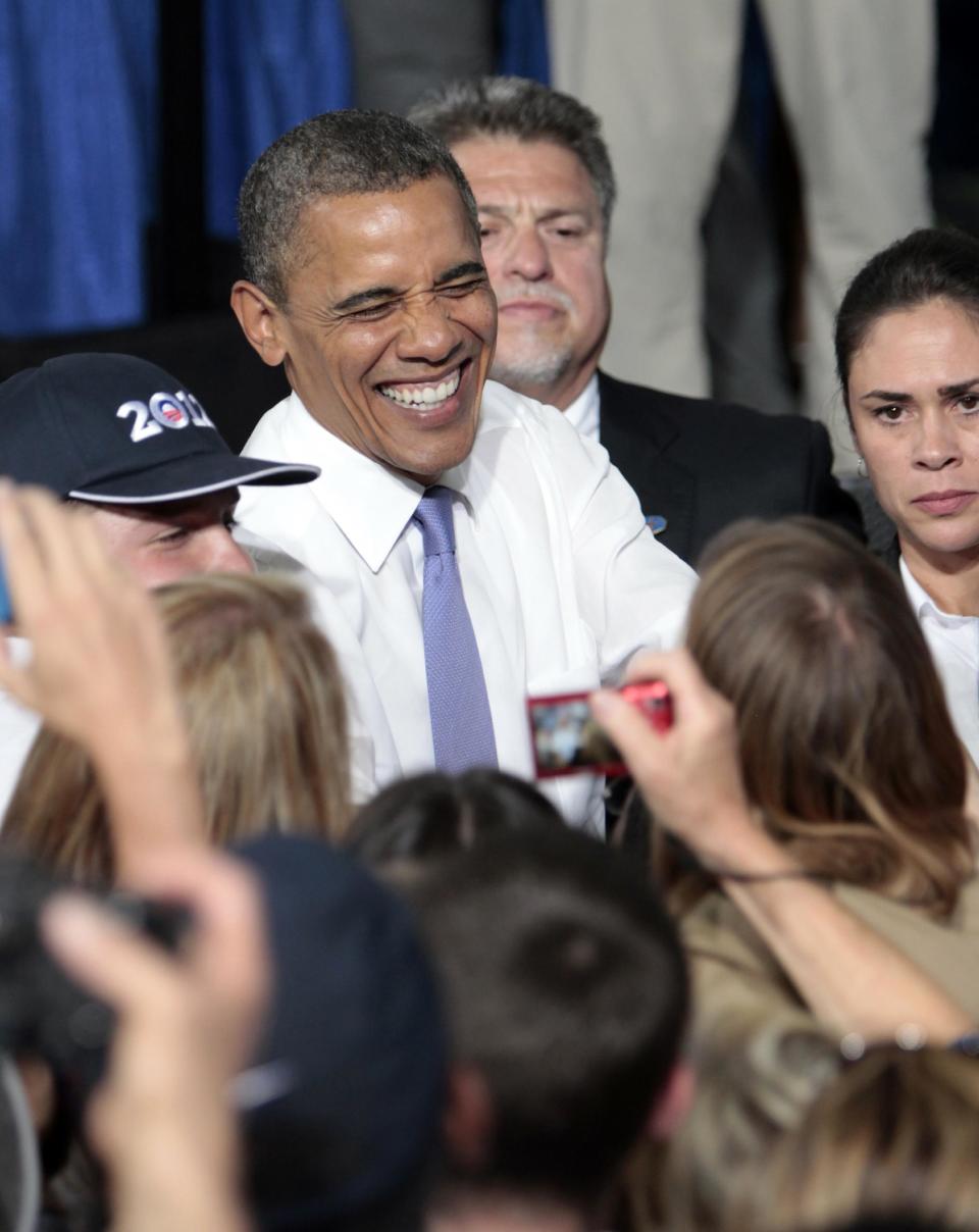 President Barack Obama laughs as he visits with supporters following his campaign stop at the Truckee Meadows Community College in Reno, Nev., Tuesday, Aug. 21, 2012. (AP Photo/Rich Pedroncelli)