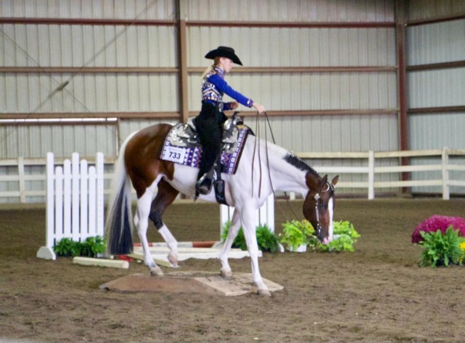 Tecumseh senior Brooke Miller takes her horse over the bridge during a competition in the 2021 season.