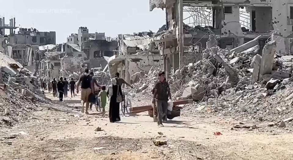 In this image taken from video, Palestinians returned to scenes of destruction in Gaza City's Shijaiyah neighborhood on Thursday, July 11, 2024, after Israeli troops withdrew following a two-week offensive. (AP Photo)