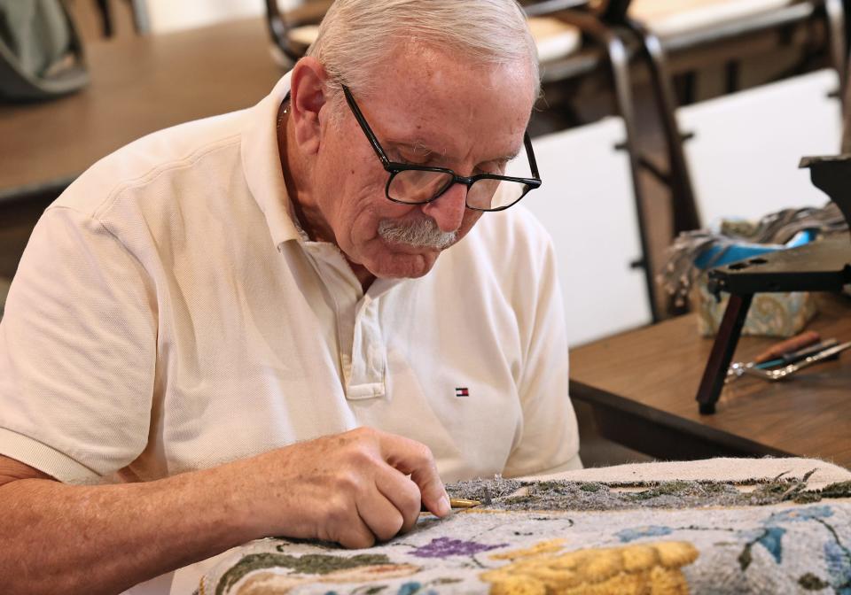 Ken Hamlin, an Adrian resident and retired educator from Adrian Public Schools, is pictured working on a rug during an October session of the Fiber Art Ministry (FAM) at the St. Joseph Campus of Holy Family Parish in Adrian.