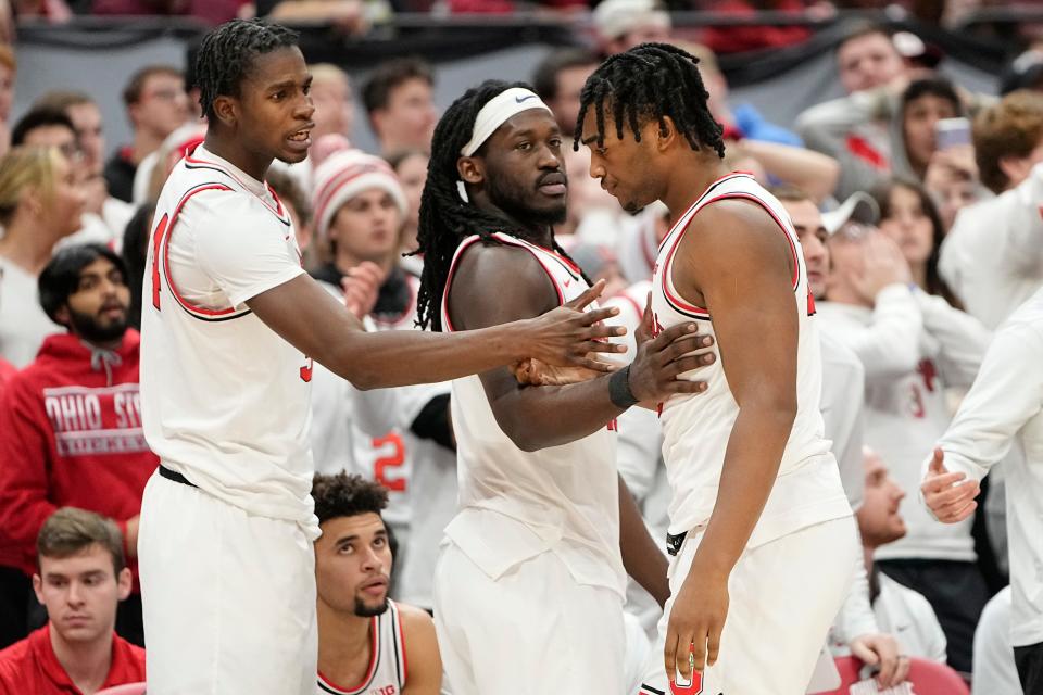 Feb 2, 2023; Columbus, OH, USA;  Ohio State Buckeyes center Felix Okpara (34) and guard Isaac Likekele (13) console forward Brice Sensabaugh (10) after he fouled out during the second half of the NCAA men’s basketball game against the Wisconsin Badgers at Value City Arena. Ohio State lost 65-60. Mandatory Credit: Adam Cairns-The Columbus Dispatch