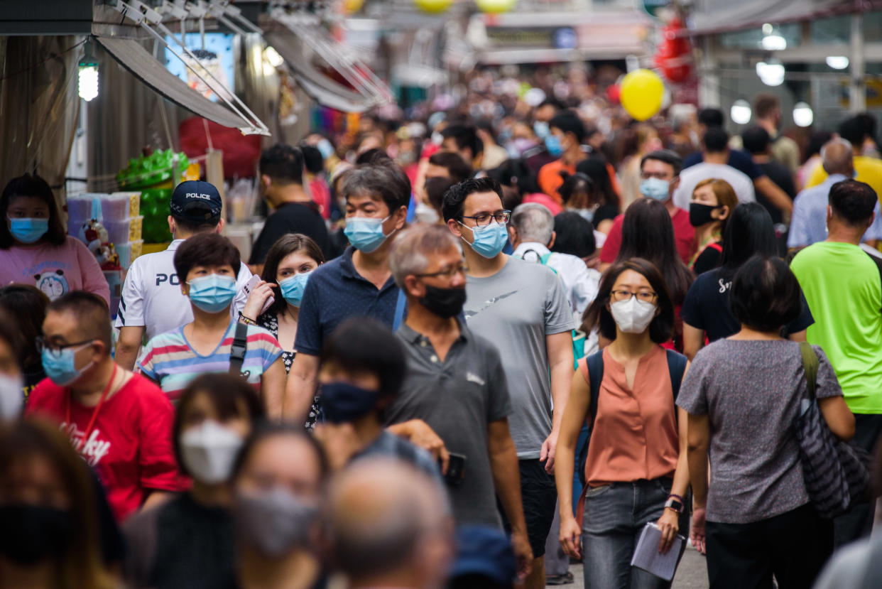 People walk in the Kreta Ayer district of Singapore, popularly known as Chinatown, ahead of the Lunar New Year festive period on Saturday, 29 January 2022.  Singapore has seen a rise in Covid-19 cases in recent weeks, including some of the BA.2 Omnicron sub-variant. (Photo by Joseph Nair/NurPhoto via Getty Images)