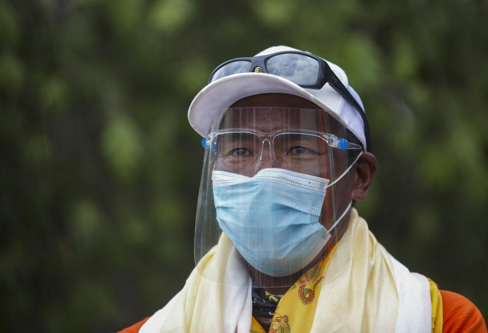 Veteran Sherpa guide Kami Rita who returned from the mountains on a helicopter arrives at the airport in Kathmandu, Nepal, Tuesday, May 25, 2021. The record-holding Sherpa climber halted his attempt to scale Mount Everest for a 26th time because of a bad dream but plans to try again next year. (AP Photos/Bikram Rai)