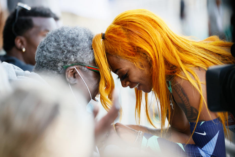 Sha'Carri Richardson celebrates winning the women's 100 meter final with grandmother Betty Harp on Saturday. She later revealead her biological mother died. (Steph Chambers/Getty Images)