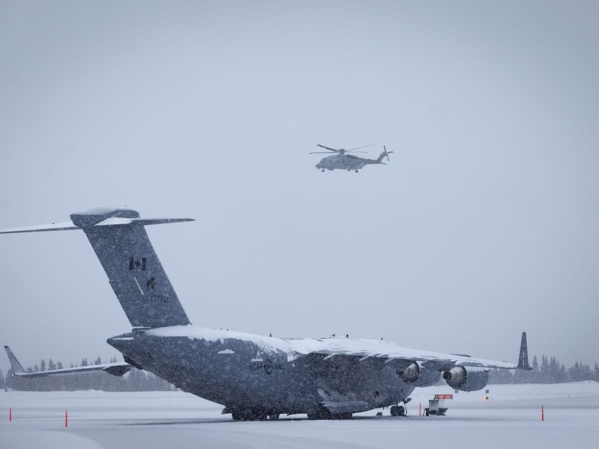 Military aircraft taking part in the search for the 'suspected balloon' are pictured at the Whitehorse airport on Feb. 13. (Evan Mitsui/CBC - image credit)