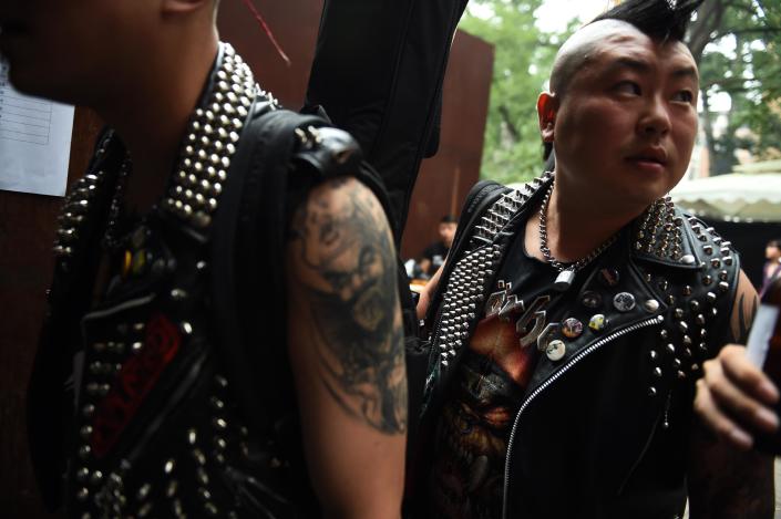 Zhou Wei (R) and Wang Shaowu of punk band The Demonstrators arrive before the band's performance at the annual Beijing Punk Festival on August 30, 2014 (AFP Photo/Greg Baker)