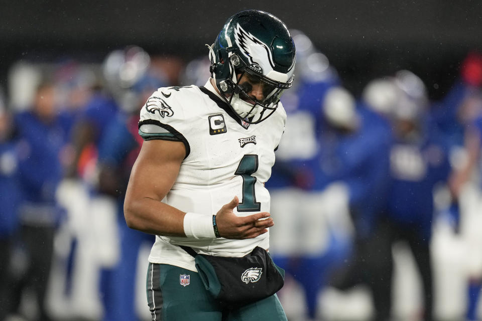 Philadelphia Eagles quarterback Jalen Hurts (1) walks off the field with a finger injury during the second quarter of an NFL football game against the New York Giants, Sunday, Jan. 7, 2024, in East Rutherford, N.J. (AP Photo/Seth Wenig)
