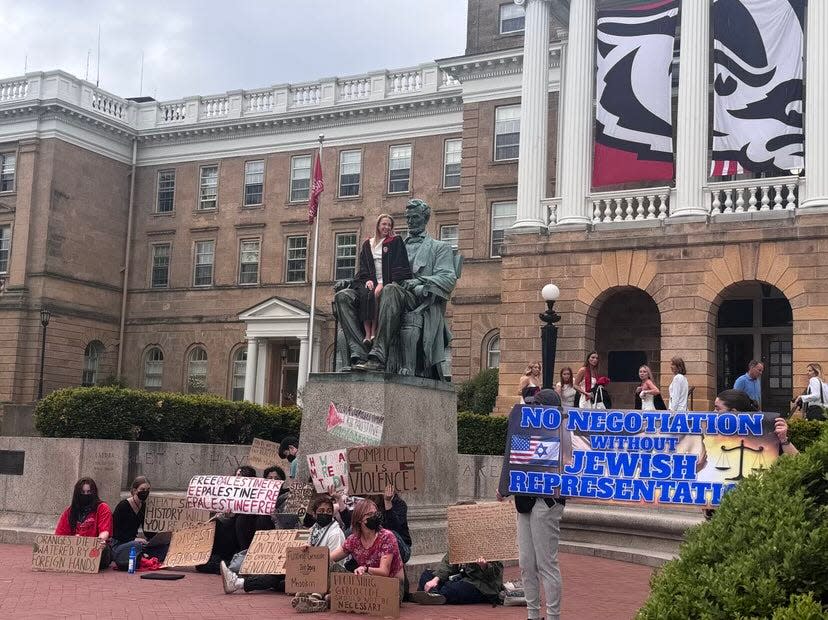 Protesters gathered around the Abraham Lincoln statute Saturday, May 4, 2024, as graduates attempted to get photos as well. Counter-protesters also appeared at the statue, asking that Jewish voices be represented at the table during negotiations between UW officials and leadership from the encampment.
