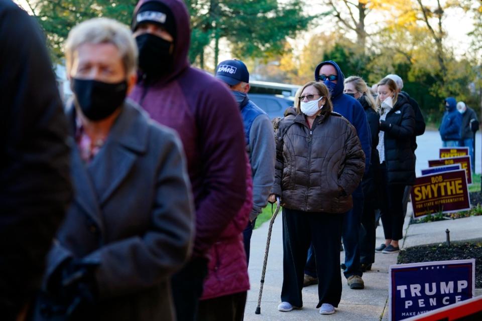 People line up outside a polling place to vote in the 2020 general election on Nov. 3 in Springfield, Pa.