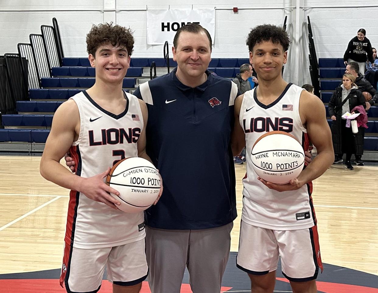 From left, Cam DiChiara, coach Jeremy Wilner, and Wayne McNamara after Tuesday's win over PCD. Both players reached the 1,000 point milestone in their Lincoln careers.