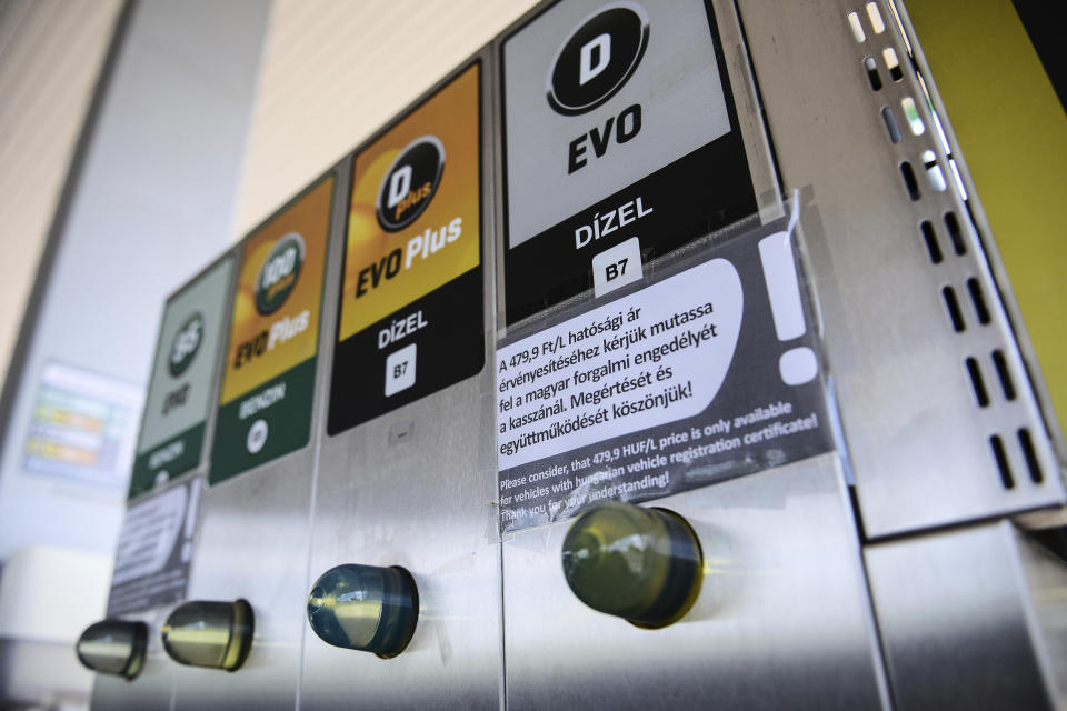 An sign at a petrol station gives information on the discount of fuel, in Budapest, Hungary, Sunday, June 12, 2022. Hungary has placed price caps on fuel and some food and imposed special taxes on industries as the government tries to ease an economic downturn and the highest inflation in nearly 25 years. (AP Photo/Anna Szilagyi)