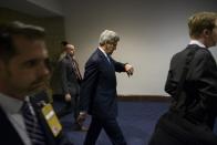 US Secretary of State John Kerry looks at his watch between meetings to brief Democrats on the Iran nuclear talks and other issues on Capitol Hill April 14, 2015 in Washington, DC