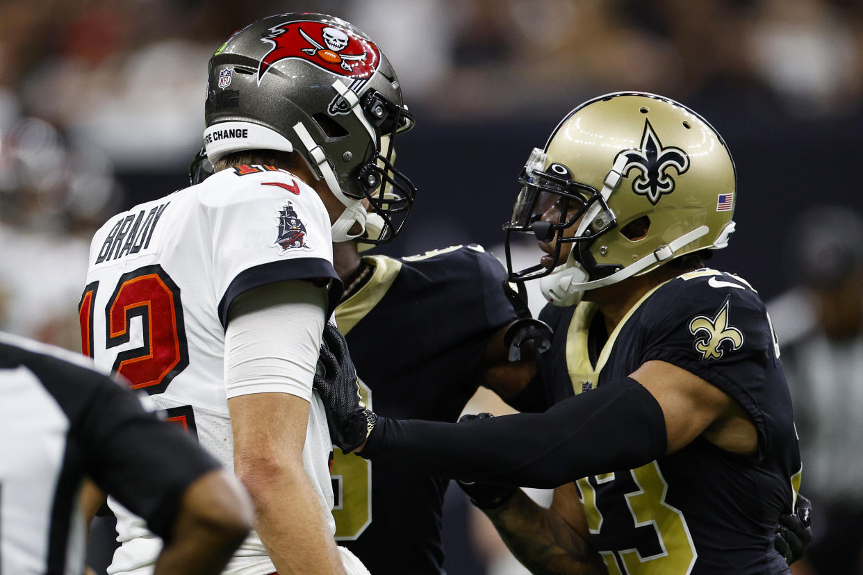 Tom Brady and Marshon Lattimore exchange words before a brawl ignites. (Photo by Chris Graythen/Getty Images)