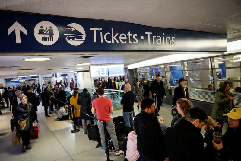 Travelers wait in the boarding area for trains during the Thanksgiving holiday travel rush at Pennsylvania Station in New York