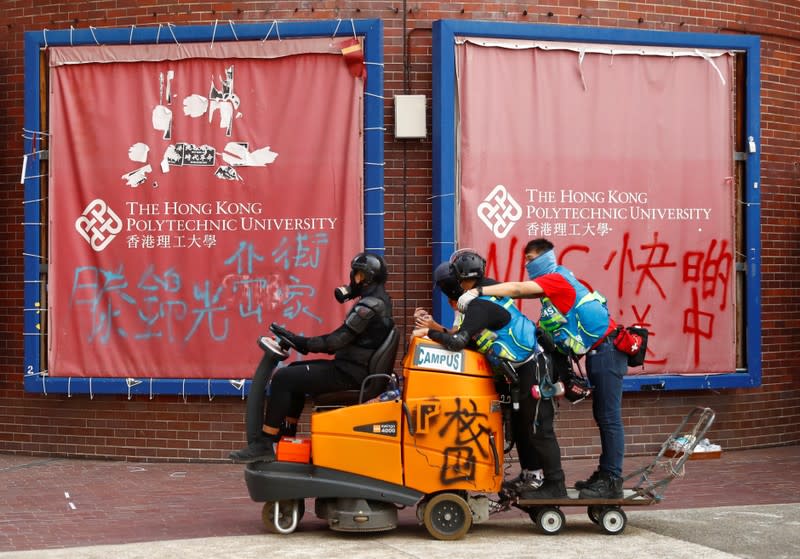 Student protesters drive a road sweeper during a demonstration at Hong Kong Polytechnic University Campus, Hong Kong