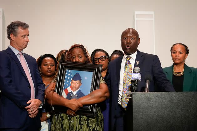 Chantemekki Fortson, mother of Roger Fortson, a senior airman, holds a photo of her son at a news conference Thursday with other family members and attorney Ben Crump, right, and Pensacola attorney Brian Barr, left, in Fort Walton Beach, Florida.