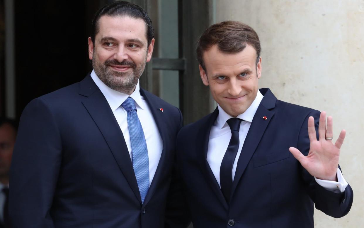 French President Emmanuel Macron (R) welcomes Lebanese Prime Minister Saad Hariri (L) at the Elysee Palace in Paris - Anadolu