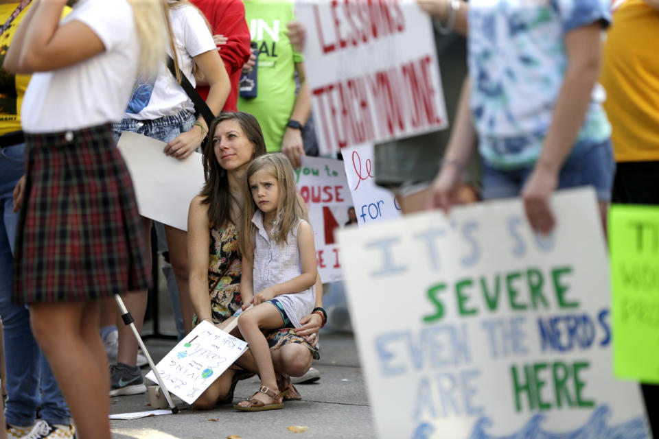 Emily Hill and her daughter Josephine Hill, 6, of Bellevue, Neb.,listen to speakers during a youth climate strike week action in Omaha, Neb., Friday, Sept. 20, 2019.  (Photo: Nati Harnik/AP)