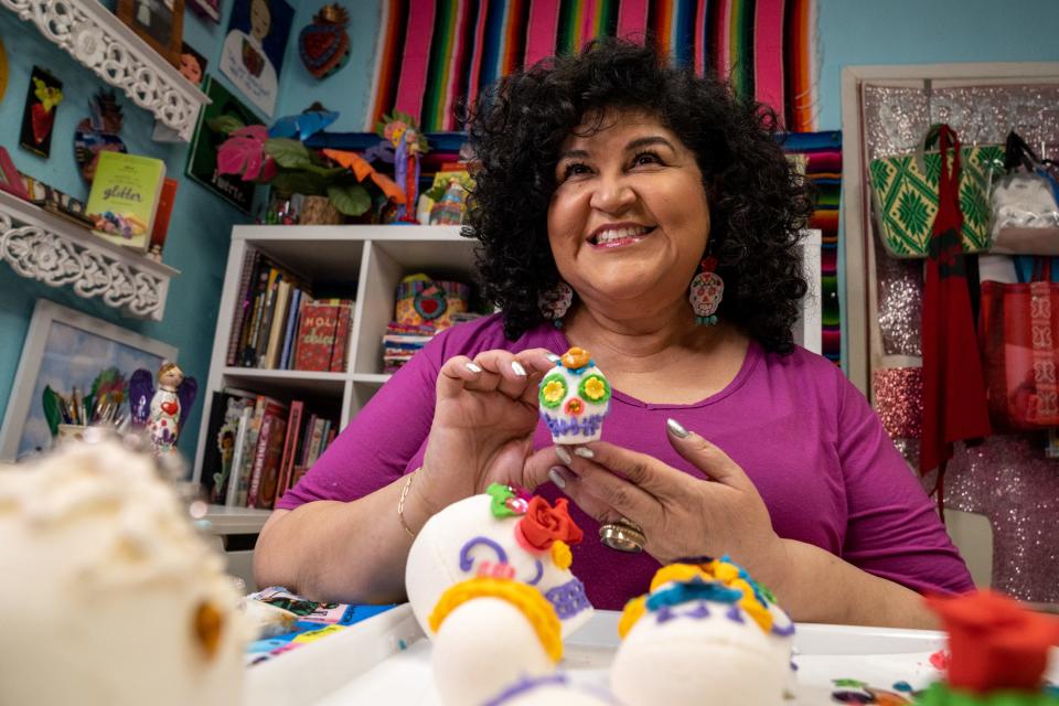 Kathy Cano-Murillo of Crafty Chica decorates Dia De Los Muertos sugar skulls at her home in Phoenix on Oct. 25, 2023.