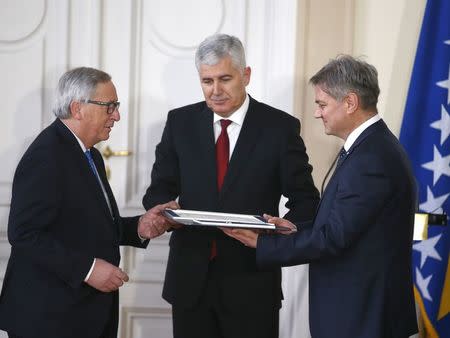 European Commission President Jean-Claude Juncker (L to R), the chairman of Bosnian Tripartite presidency Dragan Covic and Bosnian Prime Minister Denis Zvizdic during the official ceremony of answers to the European Commission's Questionnaire in Sarajevo, Bosnia and Herzegovina February 28, 2018. REUTERS/Dado Ruvic