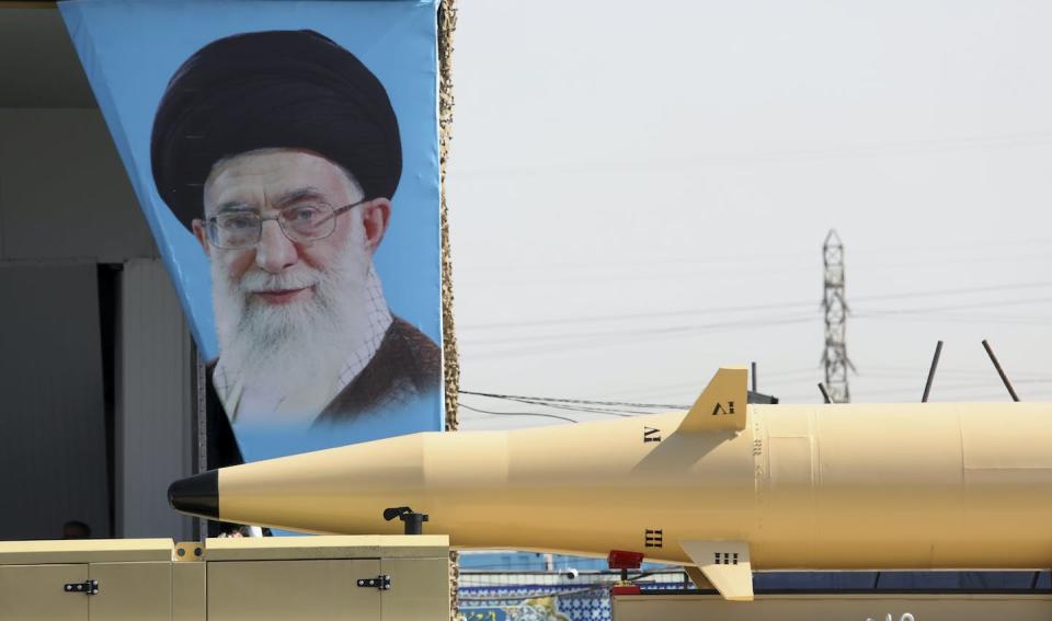 A missile is carried past a portrait of Iranian Supreme Leader Ayatollah Ali Khamenei during a military parade in September 2022. (AP Photo/Vahid Salemi)