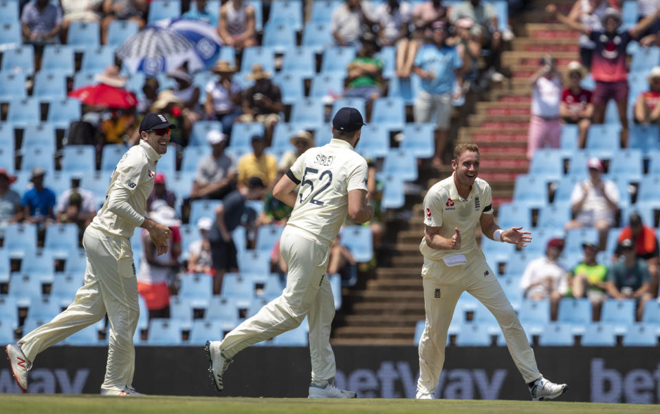 England's bowler Stuart Broad, right, celebrates with teammate after dismissing South Africa's captain Faf du Plessis for 29 runs on day one of the first cricket test match between South Africa and England at Centurion Park, Pretoria, South Africa, Thursday, Dec. 26, 2019. (AP Photo/Themba Hadebe)