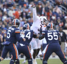 Virginia quarterback Brennan Armstrong (5) has a pass tipped by Virginia Tech defensive lineman Norell Pollard (3) in the first half of an NCAA college football game in Charlottesville, Va. Saturday Nov. 27 2021. (Matt Gentry/The Roanoke Times via AP)