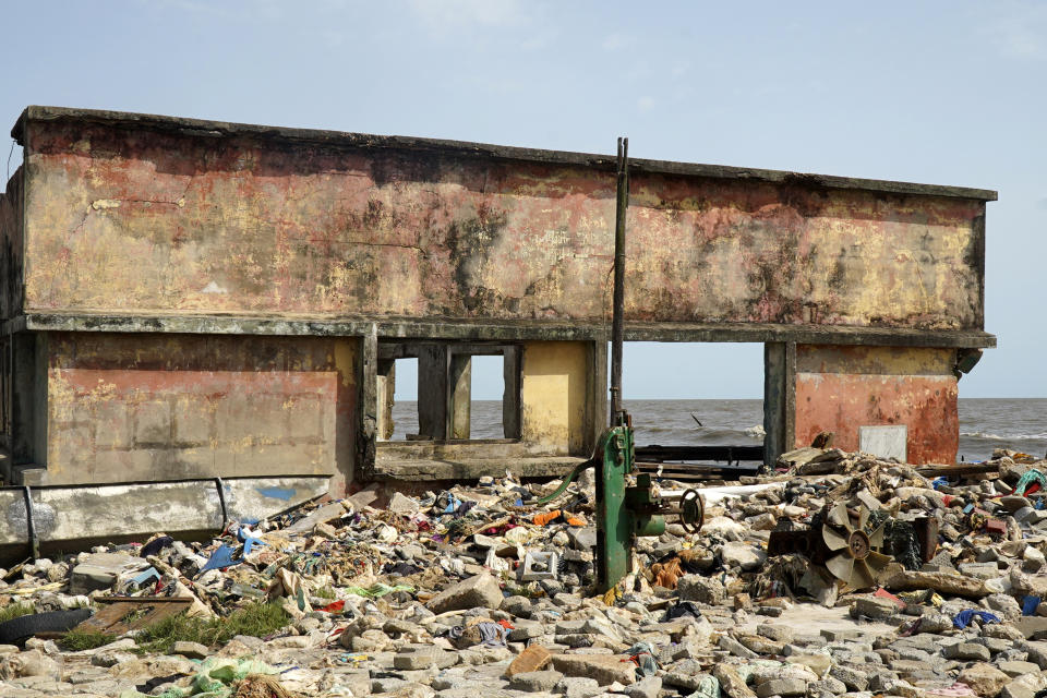 A damage house is seen due to coastal erosion in Ayetoro, Southwest Nigeria, Thursday, April 4, 2024. Ayetoro, a coastal community more than 200 km southeast of Nigeria's business capital Lagos, has been experiencing coastal erosion for many years. But the changes have recently rapidly worsened with the community slumping into the Atlantic Ocean, leading to repeated displacements of households and businesses. (AP Photo/Dan Ikpoyi)