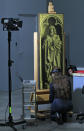 A restorer inspects one of the 24 framed panels of the Altarpiece or Adoration of the Mystic Lamb at The Genth Museum of Fine Arts October 2, 2012. The painting, considered to be one of Belgium's masterpieces and one of the world's treasures, and which was completed in 1432 by brothers Hubert and Jan van Eyck, will be restored over a five-year period. REUTERS/Yves Herman