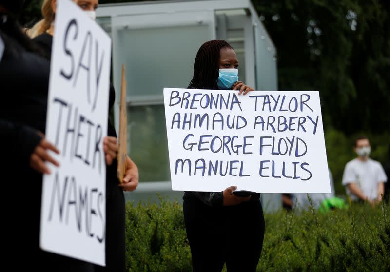 Protesters rally in Tacoma following the death of Manuel Ellis in Tacoma police custody in March and the death of George Floyd in Minneapolis police custody