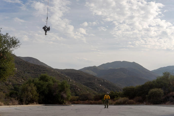 Image: A helicopter transports part of the crew from the Cleveland National Forest to a nearby parking lot. (Sydney Krantz for NBC News)