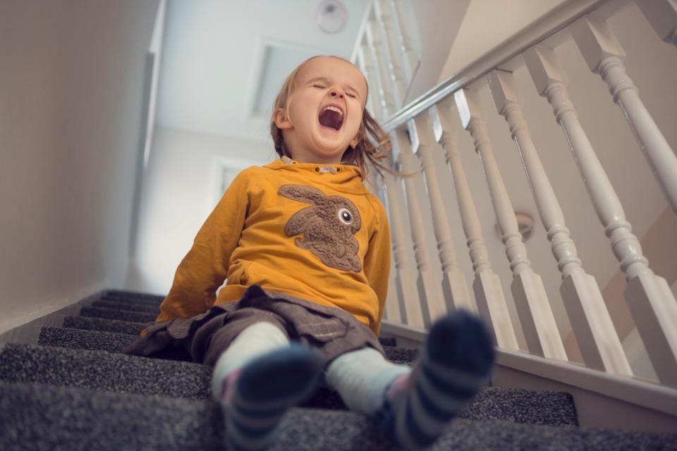A girl sliding down the stairs.