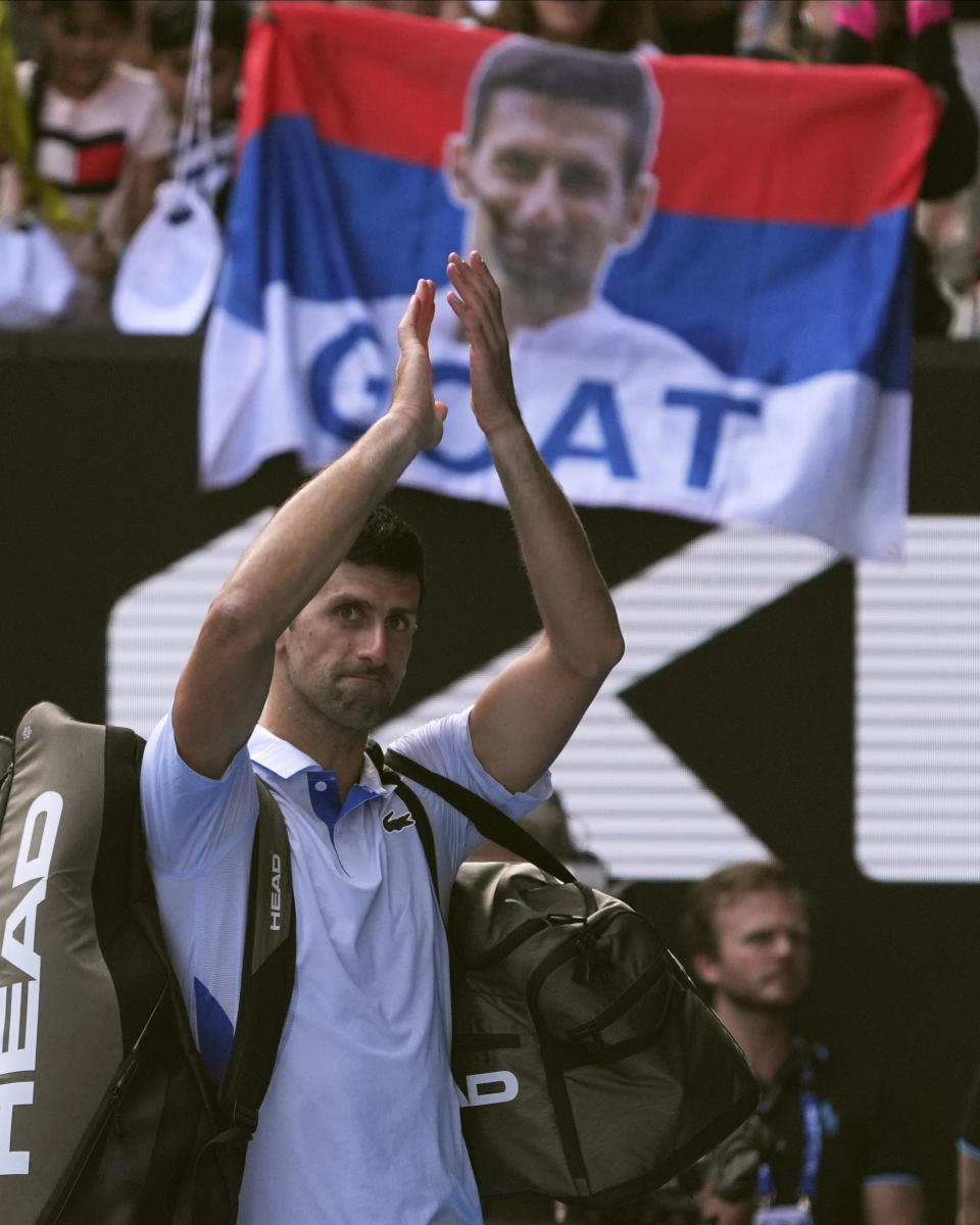 Novak Djokovic of Serbia gestures to the crowd as he leaves Rod Laver Arena following his loss to Jannik Sinner of Italy in their semifinal at the Australian Open tennis championships at Melbourne Park, Melbourne, Australia, Friday, Jan. 26, 2024. (AP Photo/Andy Wong)