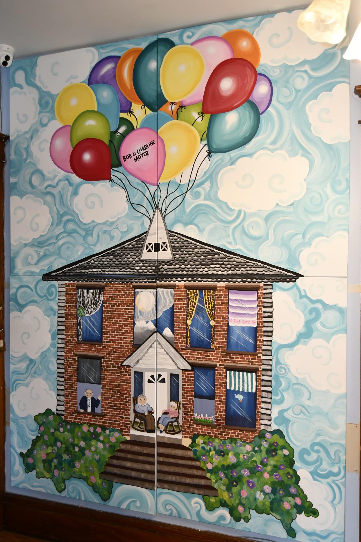 The mural in The Village House allows sponsors and donors to have their name painted on a balloon.