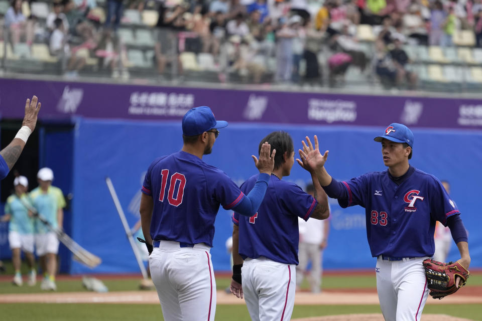 Taiwan's baseball players celebrate after winning against Hong Kong in a stage group round B Baseball Men game for the 19th Asian Games in Hangzhou, China on Tuesday, Oct. 3, 2023. At the Asian Games China has been going out of its way to be welcoming to the Taiwanese athletes, as it pursues a two-pronged strategy with the goal of taking over the island, which involves both wooing its people while threatening it militarily. (AP Photo/Ng Han Guan)