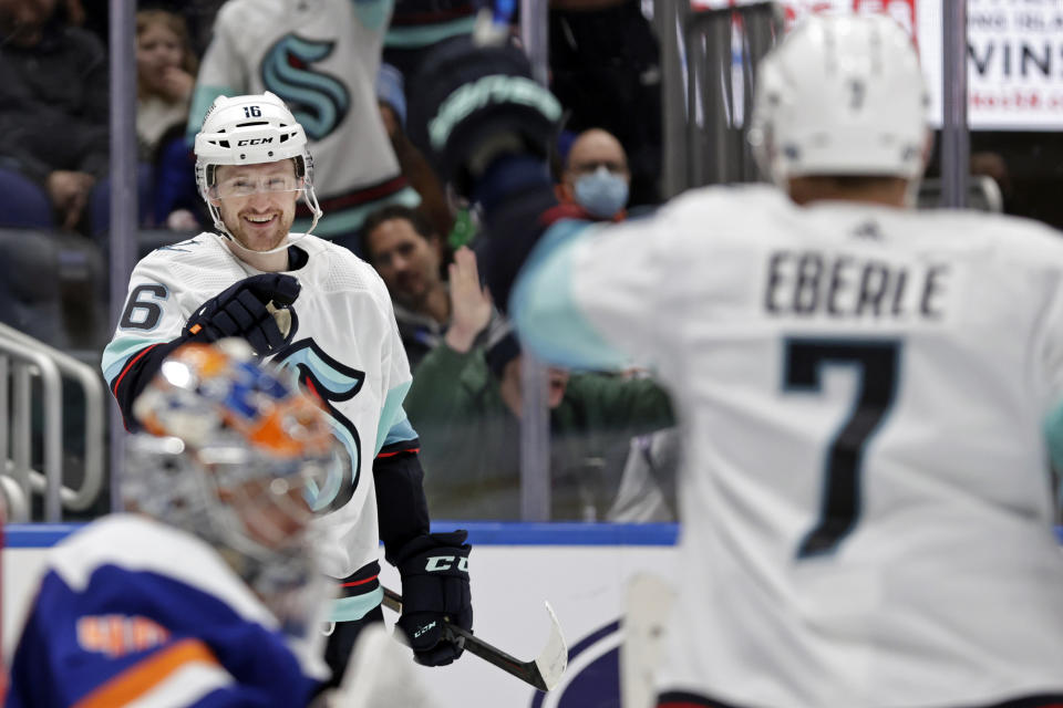 Seattle Kraken left wing Jared McCann (16) gestures towards Jordan Eberle (7) after scoring a goal past New York Islanders goaltender Semyon Varlamov in the third period of an NHL hockey game Wednesday, Feb. 2, 2022, in Elmont, N.Y. The Kraken won 3-0. (AP Photo/Adam Hunger)