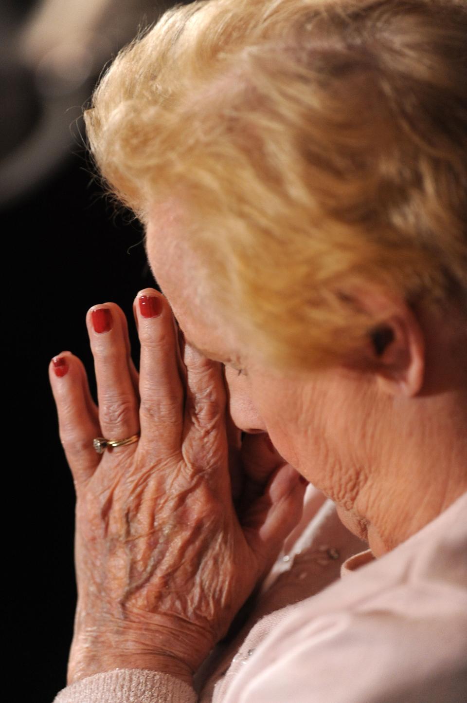 NEWTOWN, CT - DECEMBER 16: A woman prays during an interfaith vigil for the shooting victims from Sandy Hook Elementary School on December 16, 2012 at Newtown High School in Newtown, Connecticut. Twenty-six people were shot dead, including twenty children, after a gunman identified as Adam Lanza opened fire at Sandy Hook Elementary School. Lanza also reportedly had committed suicide at the scene. A 28th person, believed to be Nancy Lanza, found dead in a house in town, was also believed to have been shot by Adam Lanza. (Photo by Olivier Douliery-Pool/Getty Images)