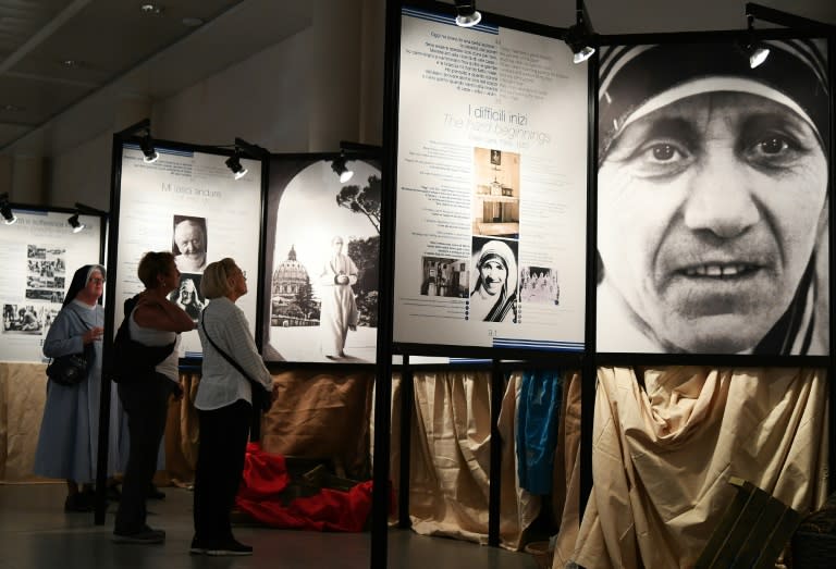 Visitors look at pictures of Mother Teresa at a photography exhibition in Rome, on September 1, 2016
