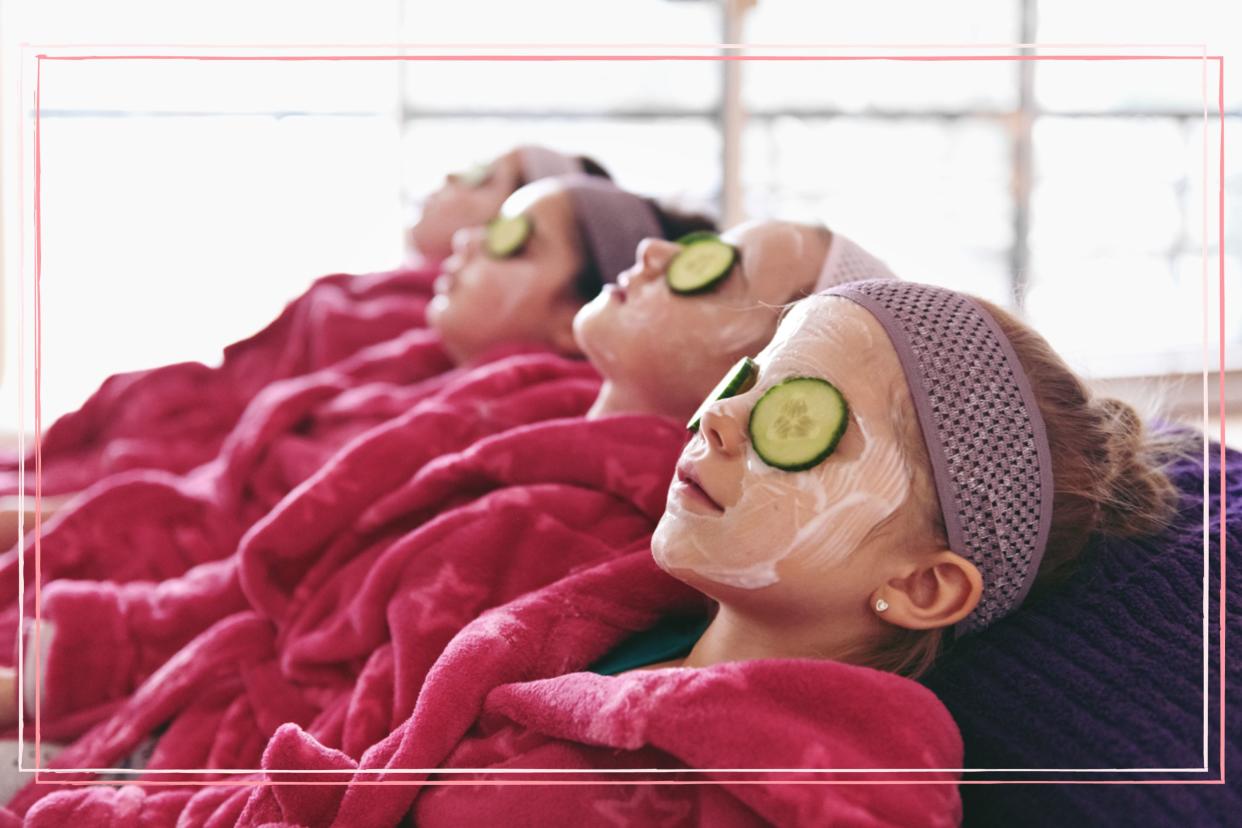  Four girls in pink dressing gowns lying with cucumber on their eyes. 