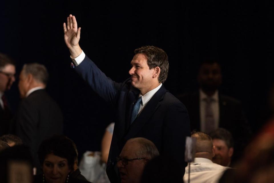 Florida Gov. Ron DeSantis waves as he arrives to the New Hampshire GOP's Amos Tuck Dinner on April 14, 2023 in Manchester, New Hampshire.  During his first trip to the state, DeSantis spoke before over 500 attendees at the annual Amos Tuck fundraising dinner for the New Hampshire Republican Party.