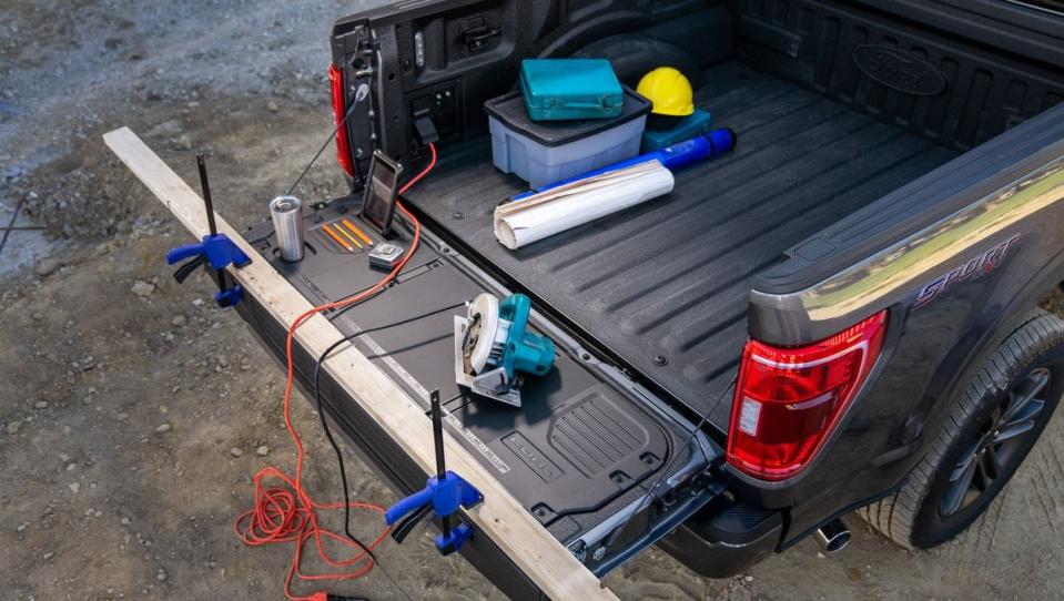 A ruler is stamped into the tailgate of an all-electric Ford F-150 Lightning so that construction workers can measure wood. Some new parents are using the ruler to track growth of their babies.